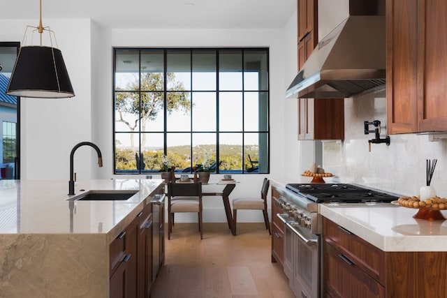 4405 Hennig Dr, Austin, TX 78738 - kitchen with ventilation hood, a sink, double oven range, light stone countertops, and tasteful backsplash