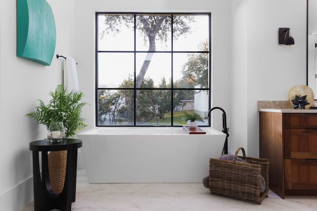 4405 Hennig Dr, Austin, TX 78738 - full bathroom with vanity, a freestanding tub, marble look tile flooring, and plenty of natural light