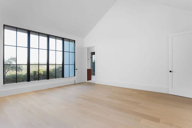 4405 Hennig Dr, Austin, TX 78738 - unfurnished room with high vaulted ceiling, light wood-style floors, and baseboards