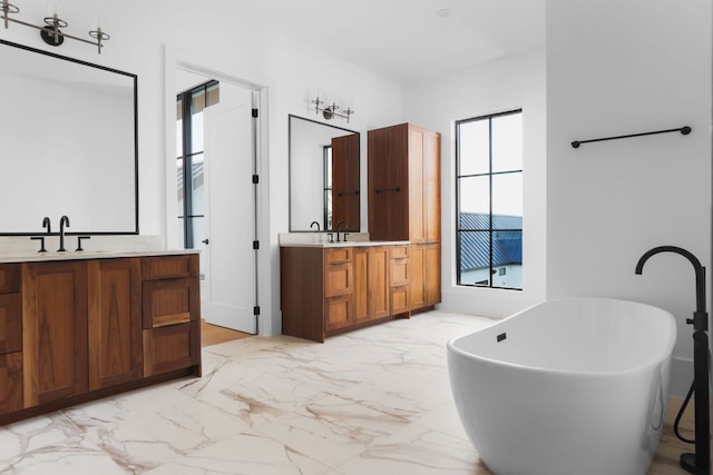 4405 Hennig Dr, Austin, TX 78738 - bathroom featuring marble finish flooring, two vanities, and a soaking tub