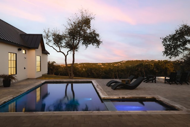 4405 Hennig Dr, Austin, TX 78738 - pool at dusk with a patio, an outdoor pool, and a hot tub