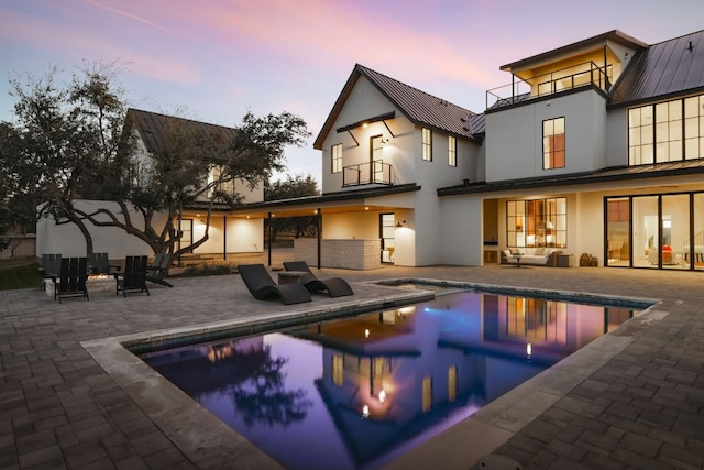 4405 Hennig Dr, Austin, TX 78738 - back of house featuring a balcony, stucco siding, a patio, and an outdoor hangout area