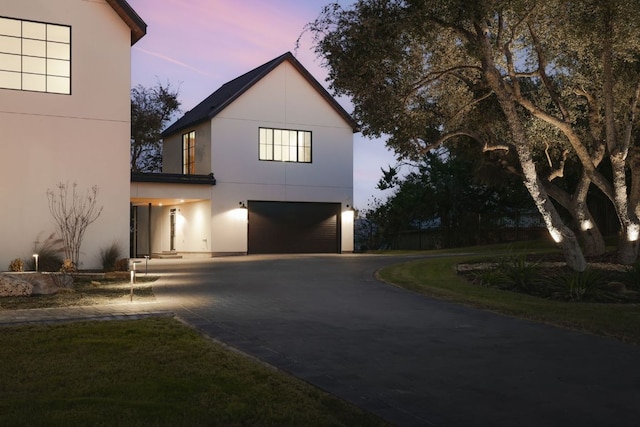 4405 Hennig Dr, Austin, TX 78738 - view of front facade featuring driveway, an attached garage, and stucco siding