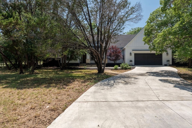 4 La Toya Trl, Wimberley, TX 78676 - view of front facade featuring driveway, a garage, and a front lawn