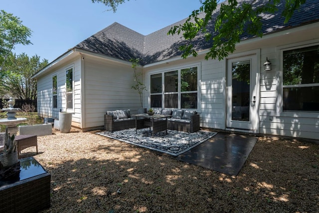 back of house featuring an outdoor hangout area, a patio area, and a shingled roof