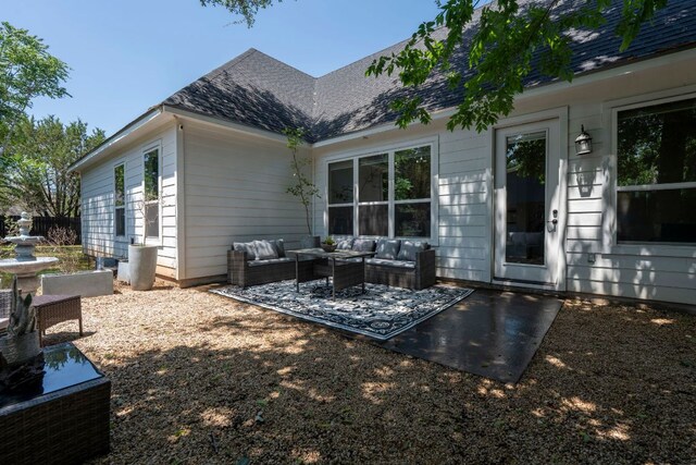 4 La Toya Trl, Wimberley, TX 78676 - rear view of house featuring outdoor lounge area, a patio, and roof with shingles