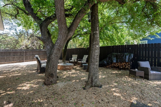 fenced backyard featuring an outdoor fire pit and a patio
