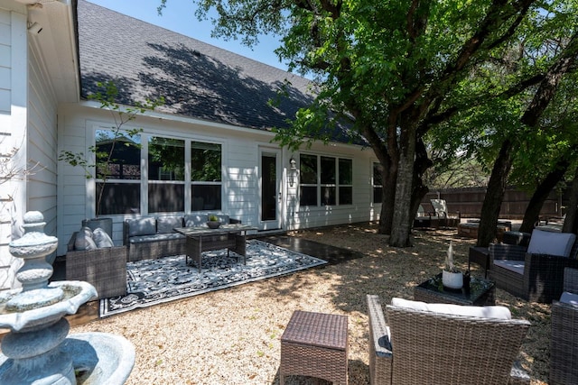 back of house with a patio area, outdoor lounge area, roof with shingles, and fence