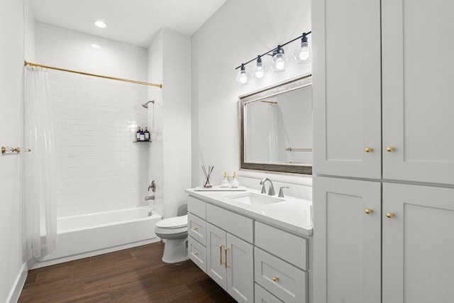 bathroom featuring wood finished floors, toilet, vanity, and shower / bathtub combination with curtain