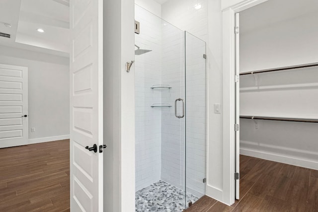 4 La Toya Trl, Wimberley, TX 78676 - bathroom featuring a stall shower, a walk in closet, wood finished floors, and recessed lighting