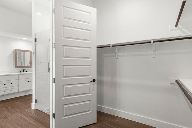 spacious closet with dark wood-style floors
