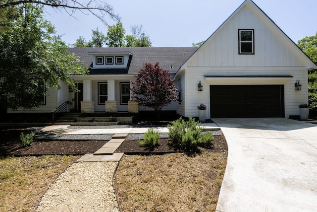 view of front of house with board and batten siding, a shingled roof, concrete driveway, and an attached garage