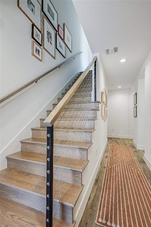 4609 Unity Cir, Austin, TX 78731 - stairs with recessed lighting, baseboards, and wood finished floors