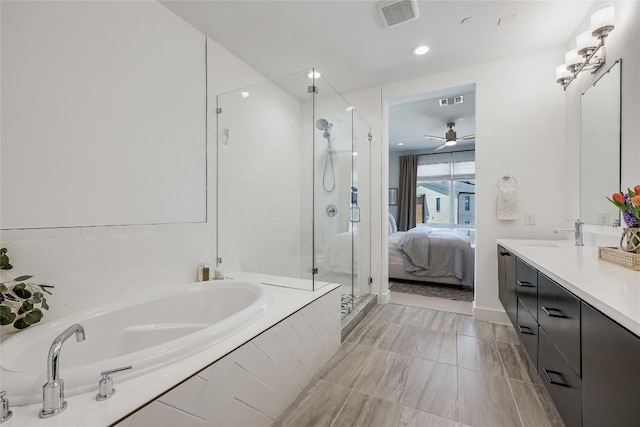 4609 Unity Cir, Austin, TX 78731 - full bathroom featuring a garden tub, a shower stall, vanity, ceiling fan, and recessed lighting
