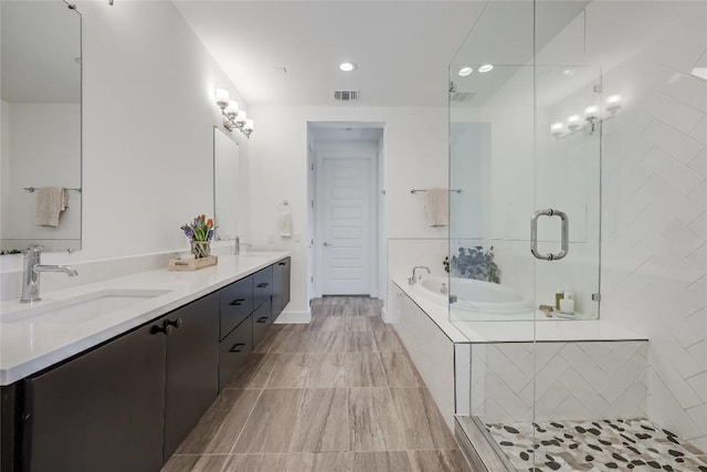 4609 Unity Cir, Austin, TX 78731 - full bath featuring double vanity, a bath, a stall shower, and recessed lighting