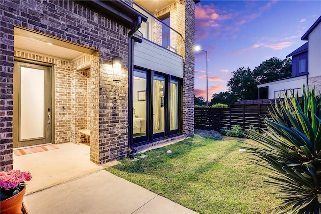 4609 Unity Cir, Austin, TX 78731 - exterior entry at dusk featuring brick siding and stone siding