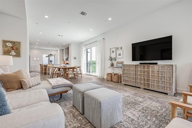 4609 Unity Cir, Austin, TX 78731 - living area featuring wood finished floors and recessed lighting