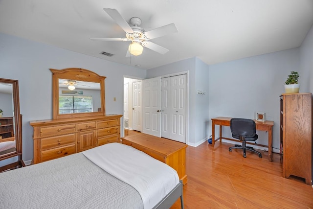 315 Juniper Dr, Mountain City, TX 78610 - bedroom with light wood-style floors, a closet, a ceiling fan, baseboards, and a desk