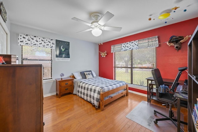 315 Juniper Dr, Mountain City, TX 78610 - bedroom featuring wood-type flooring, a desk, baseboards, and a ceiling fan