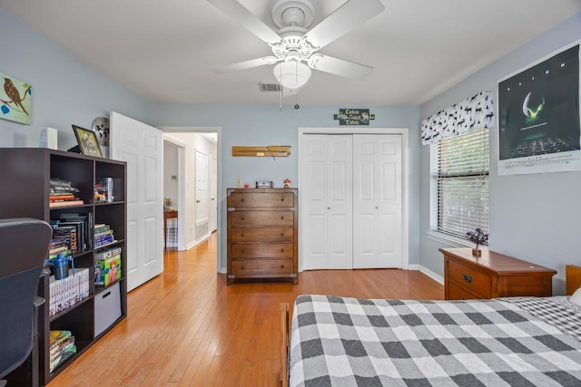315 Juniper Dr, Mountain City, TX 78610 - bedroom featuring wood-type flooring, a closet, baseboards, and a ceiling fan