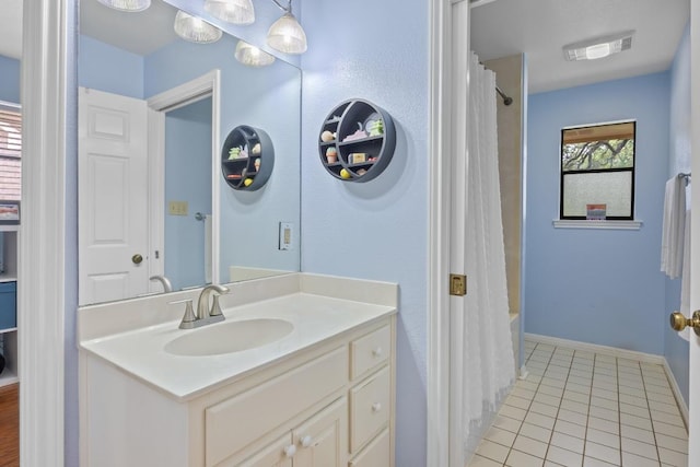 315 Juniper Dr, Mountain City, TX 78610 - bathroom featuring tile patterned flooring, vanity, shower / bath combination with curtain, and baseboards