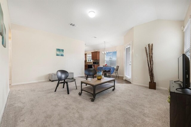 living room featuring carpet, a chandelier, and baseboards
