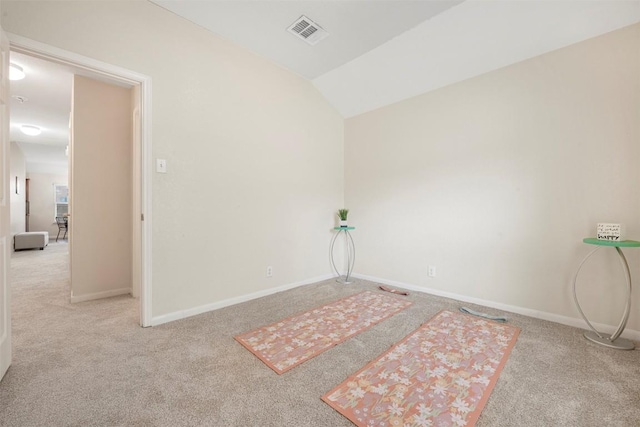 unfurnished room with carpet flooring, baseboards, and vaulted ceiling