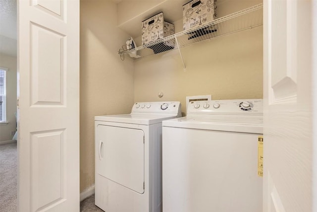 laundry area featuring washing machine and clothes dryer and baseboards