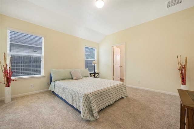 carpeted bedroom featuring baseboards and vaulted ceiling