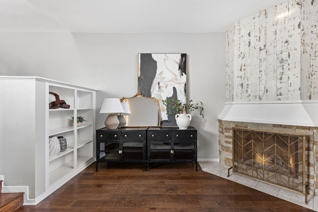 7122 Wood Hollow Dr Unit 13, Austin, TX 78731 - sitting room featuring wood finished floors and a stone fireplace
