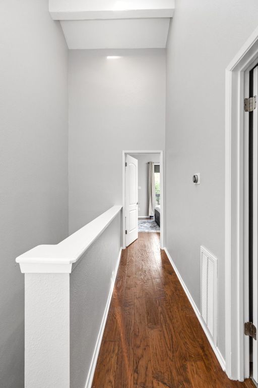 7122 Wood Hollow Dr Unit 13, Austin, TX 78731 - corridor featuring dark wood finished floors, an upstairs landing, and a high ceiling