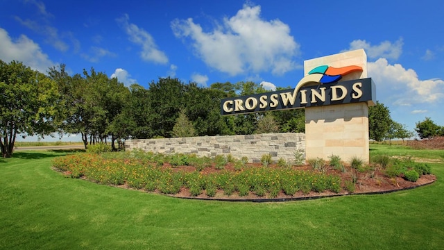 community / neighborhood sign with a lawn