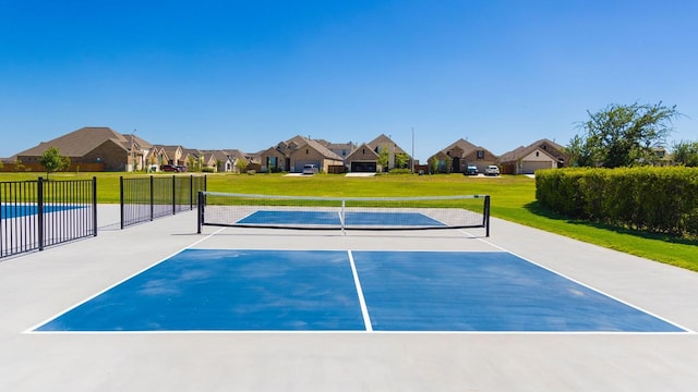 view of tennis court featuring a residential view
