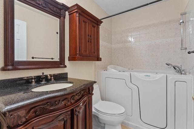531 Dennis Dr, Round Rock, TX 78664 - full bathroom with vanity, toilet, tile walls, and shower / bathtub combination