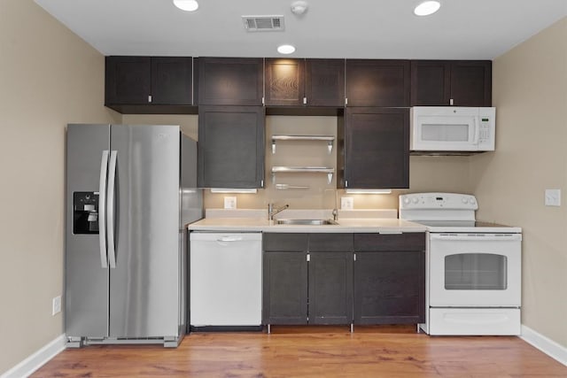 531 Dennis Dr, Round Rock, TX 78664 - kitchen with white appliances, a sink, baseboards, light wood-style floors, and light countertops