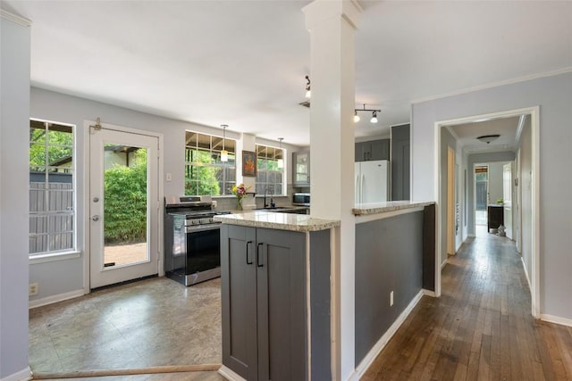 5900 Nasco Dr, Austin, TX 78757 - kitchen with appliances with stainless steel finishes, baseboards, a sink, and light stone counters