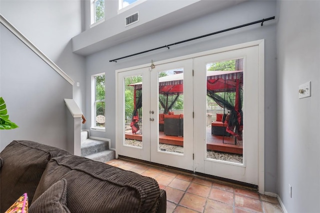 5900 Nasco Dr, Austin, TX 78757 - entryway with stairs, french doors, light tile patterned floors, and baseboards