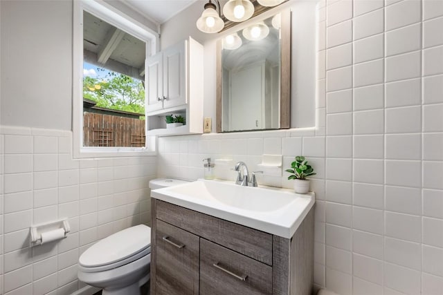 5900 Nasco Dr, Austin, TX 78757 - bathroom featuring tile walls, vanity, and toilet