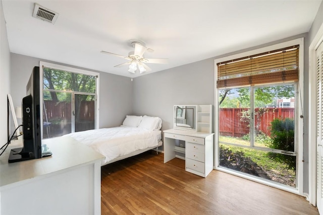 5900 Nasco Dr, Austin, TX 78757 - bedroom with multiple windows, wood finished floors, and a ceiling fan