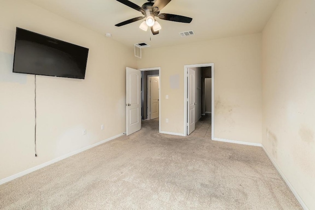 unfurnished bedroom featuring light carpet, baseboards, and ceiling fan