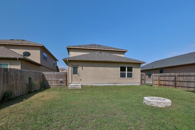rear view of house with an outdoor fire pit