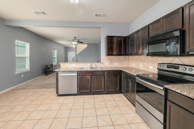 kitchen featuring stainless steel appliances, a sink, ceiling fan, backsplash, and dark brown cabinetry