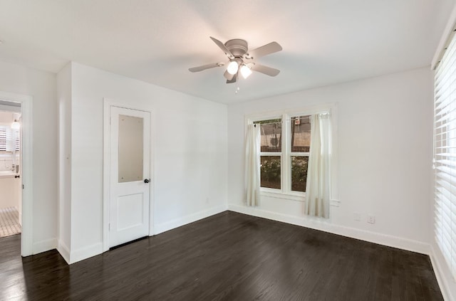 701 Bouldin Ave, Austin, TX 78704 - spare room featuring dark wood-type flooring, a ceiling fan, and baseboards