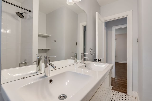 701 Bouldin Ave, Austin, TX 78704 - bathroom with double vanity, baseboards, and a shower
