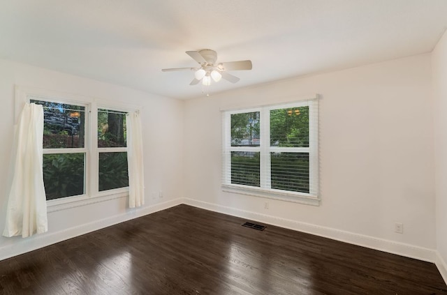 701 Bouldin Ave, Austin, TX 78704 - unfurnished room featuring ceiling fan, dark wood-style floors, and baseboards