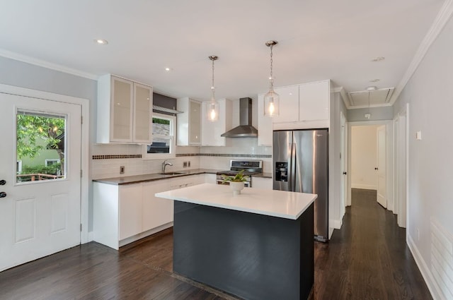 701 Bouldin Ave, Austin, TX 78704 - kitchen with wall chimney exhaust hood, appliances with stainless steel finishes, a sink, tasteful backsplash, and white cabinetry