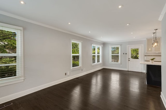 701 Bouldin Ave, Austin, TX 78704 - unfurnished living room featuring dark wood-style floors, crown molding, baseboards, and recessed lighting