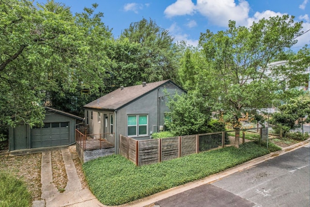 701 Bouldin Ave, Austin, TX 78704 - bungalow-style home featuring an outbuilding, a detached garage, stucco siding, and driveway
