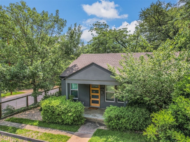 701 Bouldin Ave, Austin, TX 78704 - view of front facade with a porch, roof with shingles, and stucco siding