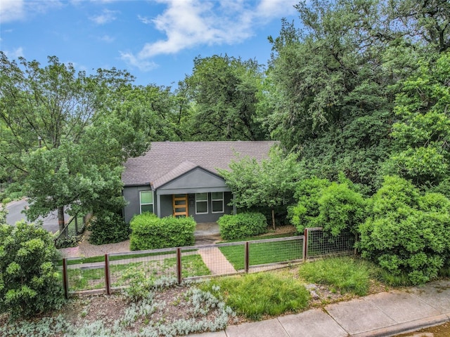 701 Bouldin Ave, Austin, TX 78704 - view of front facade featuring a fenced front yard, roof with shingles, a porch, and stucco siding